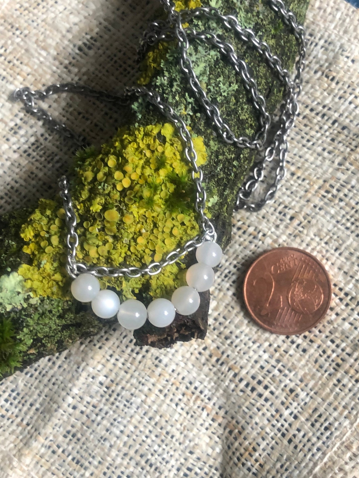 Moonstone & 9ct White Gold on a tumbled steel necklace.